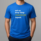 Person wearing a blue t-shirt with text 'eat up drop sleep BARBAYDOHS repeat.'