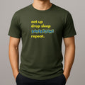 Person wearing a khaki green t-shirt with text 'eat up drop sleep BARBAYDOHS repeat.'