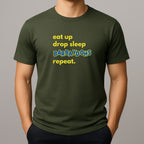 Person wearing a khaki green t-shirt with text 'eat up drop sleep BARBAYDOHS repeat.'