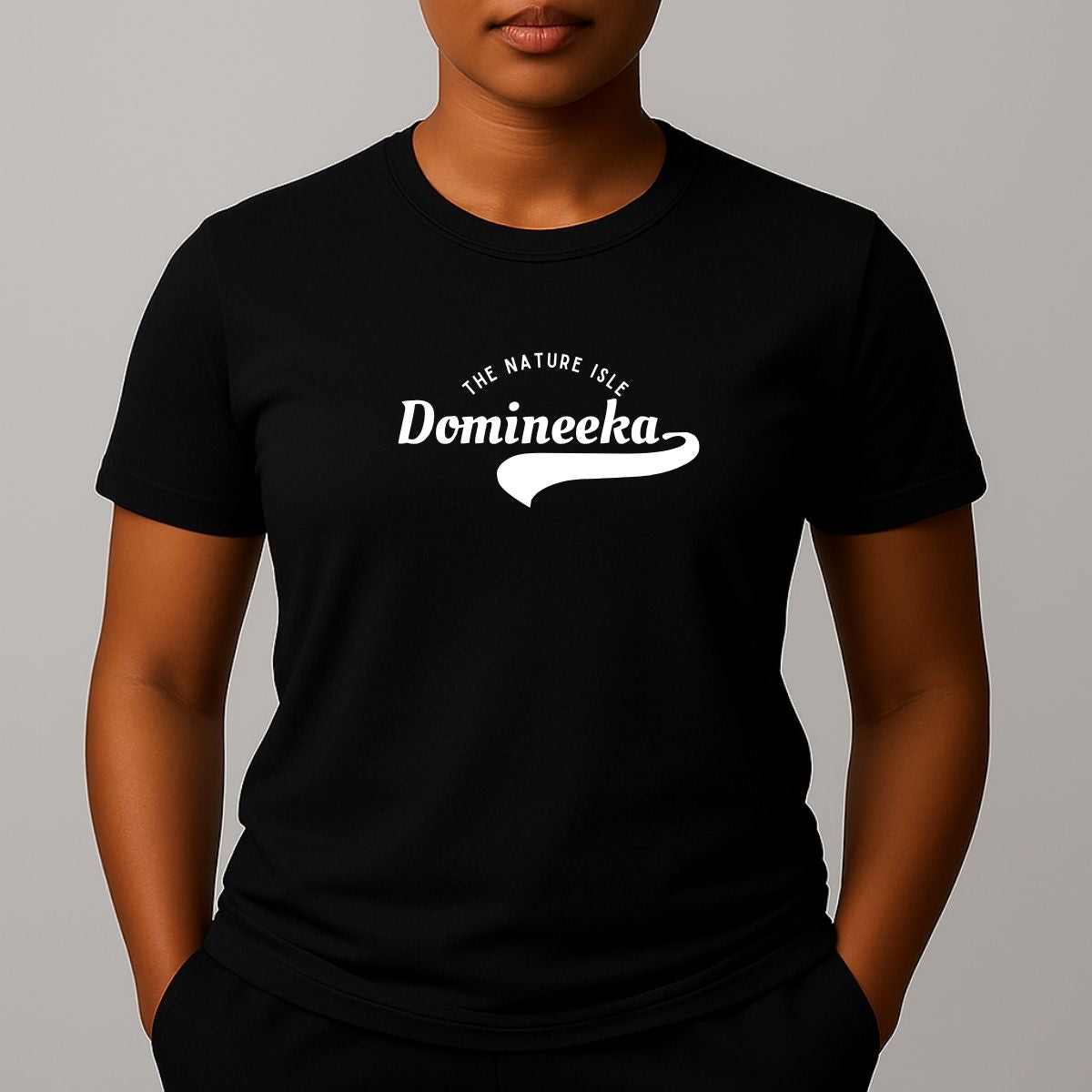Person wearing a black t-shirt with a white graphic print that reads 'THE NATURE ISLE' and a phonetic spelling of 'DOMINEEKA'.
