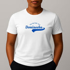 Person wearing a white t-shirt with a blue graphic print that reads 'THE NATURE ISLE' and a phonetic spelling of 'DOMINEEKA'.