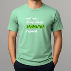 Light green t-shirt with text 'eat up drop sleep JAHMAYKA repeat.' on a gray background
