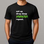 Black t-shirt with text 'eat up drop sleep JAHMAYKA repeat' on a gray background