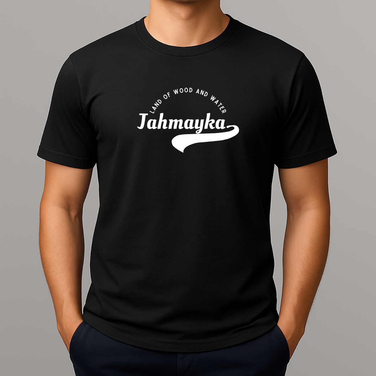 Person wearing a black t-shirt with a white graphic that phonetically spells Jamaica as 'Jahmayka' and 'LAND OF WOOD AND WATER'.