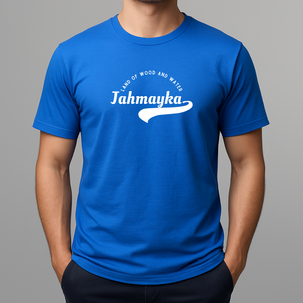 Person wearing a bright blue t-shirt with a white graphic that phonetically spells Jamaica as 'Jahmayka' and 'LAND OF WOOD AND WATER'.