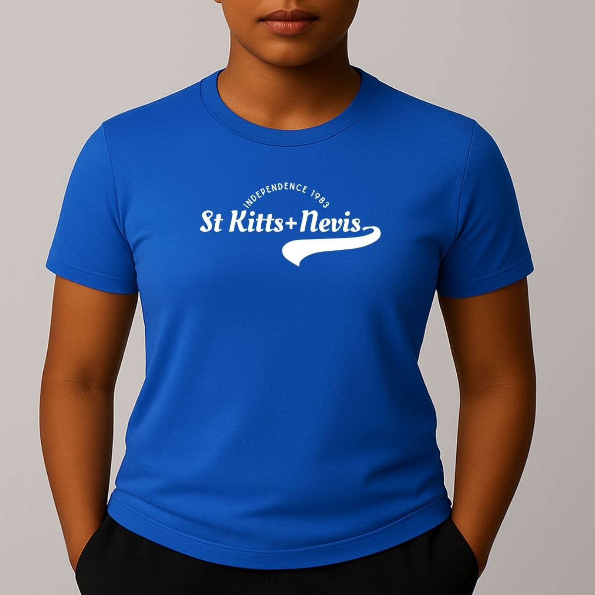Person wearing a blue short sleeve t-shirt with a white 'St Kitts+Nevis' graphic on the chest.