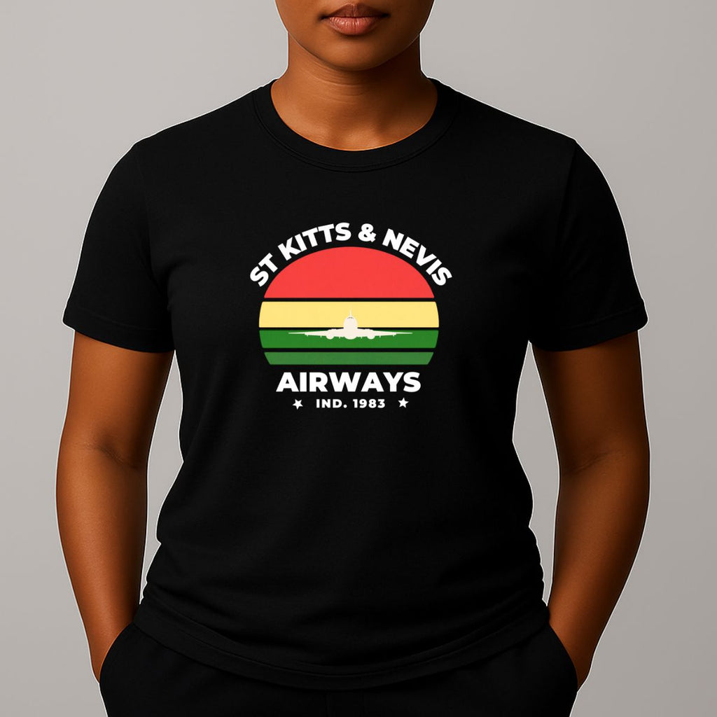 Person wearing a black t-shirt with a graphic print on the chest, featuring the text 'ST KITTS & NEVIS AIRWAYS' in white, surrounding a circular flag design with red, yellow, and green horizontal bands and a white airplane silhouette.