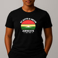 Person wearing a black t-shirt with a graphic print on the chest, featuring the text 'ST KITTS & NEVIS AIRWAYS' in white, surrounding a circular flag design with red, yellow, and green horizontal bands and a white airplane silhouette.