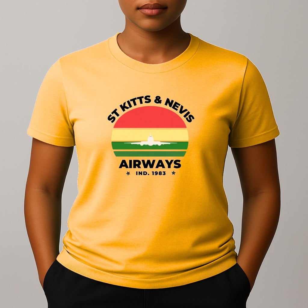 Person wearing a yellow t-shirt with a graphic print on the chest, featuring the text 'ST KITTS & NEVIS AIRWAYS' in black, surrounding a circular flag design with red, yellow, and green horizontal bands and a white airplane silhouette.
