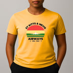Person wearing a yellow t-shirt with a graphic print on the chest, featuring the text 'ST KITTS & NEVIS AIRWAYS' in black, surrounding a circular flag design with red, yellow, and green horizontal bands and a white airplane silhouette.