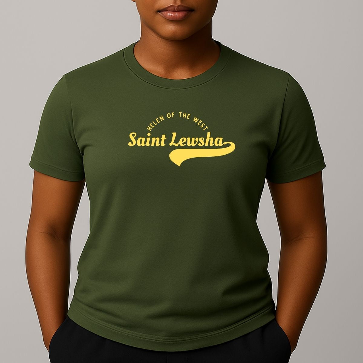 Person wearing a khaki green crewneck t-shirt with a yellow graphic that reads 'Saint Lewsha' and 'HELEN OF THE WEST' on the chest.