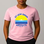 Person wearing an pink t-shirt with a graphic print that reads 'ST LEW-SHUN AIRWAYS IND. 1979' in blue, above and below a colourful striped circle with a white airplane in the center.