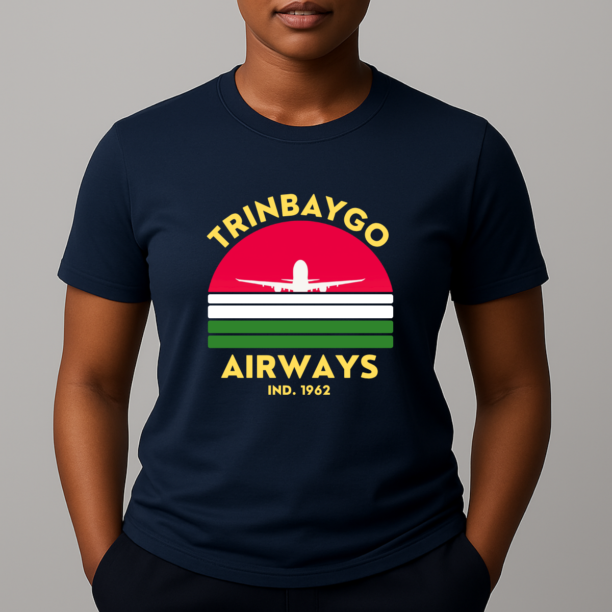 Person wearing a navy T-shirt with a colorful front graphic that reads "TRINBAYGO AIRWAYS IND. 1962" with an airplane silhouette.