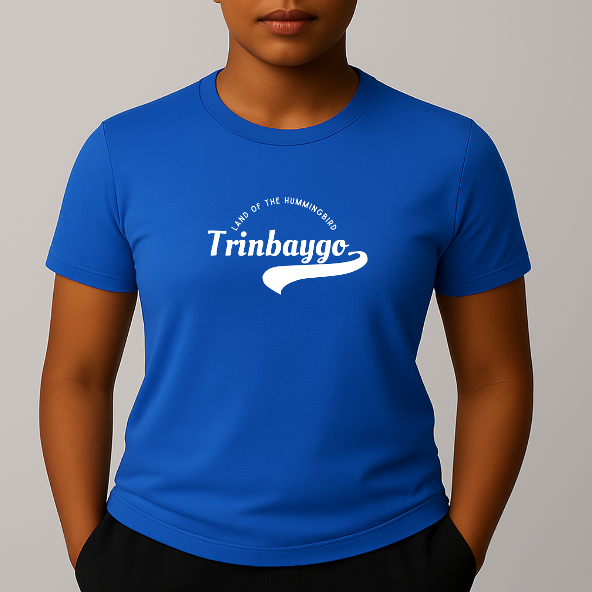 Person wearing a blue t-shirt with a white graphic print with a phonetic spelling that reads 'Trinbaygo' and 'LAND OF THE HUMMINGBIRD'.