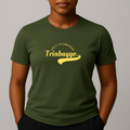 Person wearing a khaki green t-shirt with a yellow graphic print with a phonetic spelling that reads 'Trinbaygo' and 'LAND OF THE HUMMINGBIRD'.