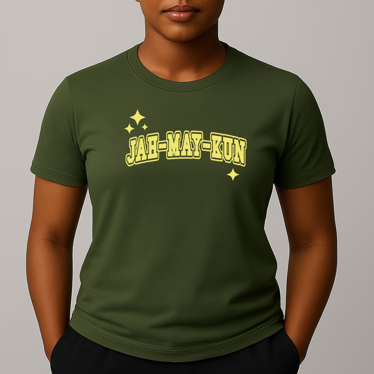 Person wearing a khaki green t-shirt with 'JAH-MAY-KUN' printed in yellow on a plain background