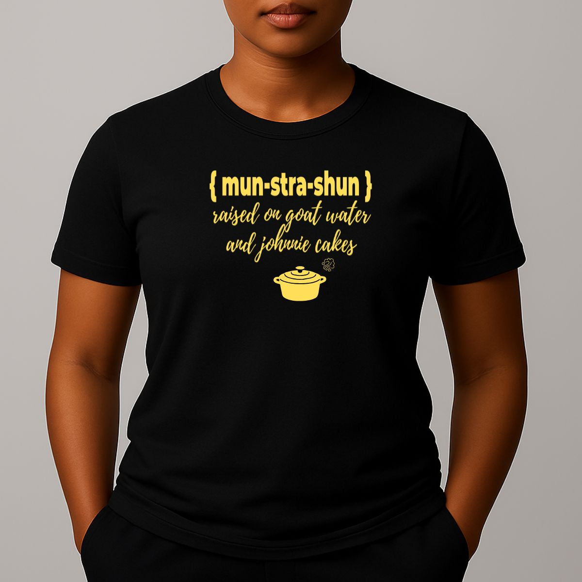 Person wearing a black t-shirt with yellow graphic and text 'mun-stra-shun'